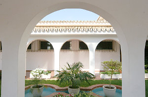 Photo through an arc of arcades in the green patio